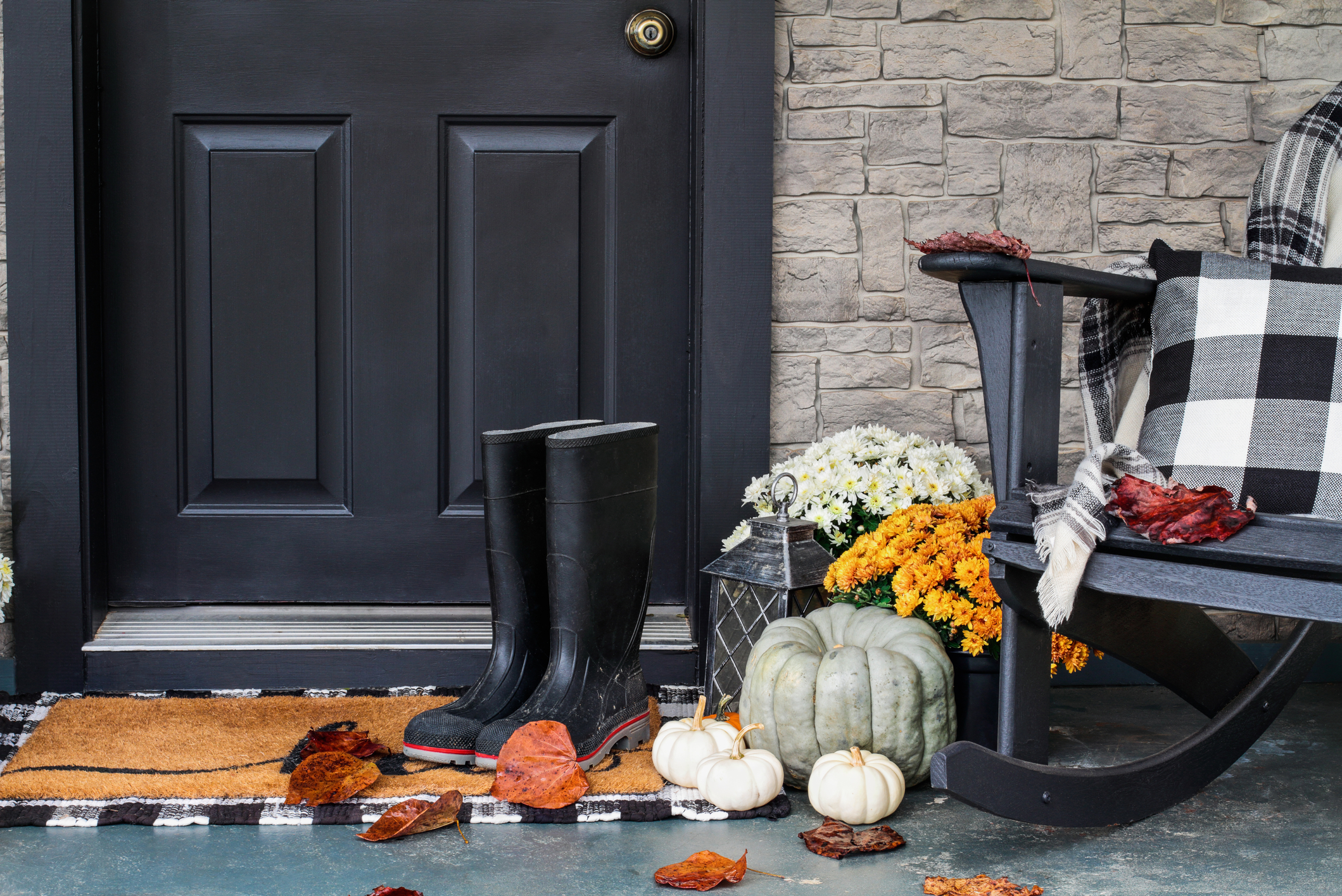 fall porch monochromatic grey, black and white with blanket and boots