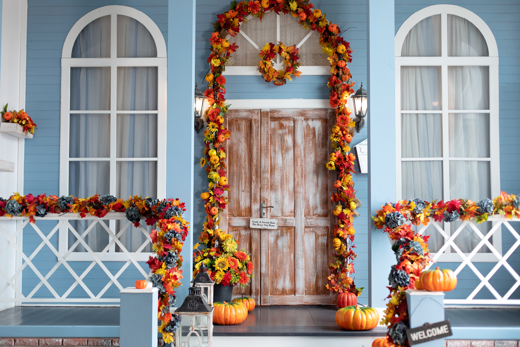 faux fall leaves and pumpkins to decorate your porch for fall